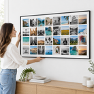 Une femme accroche la toile photo Instawall Canvas Wide avec châssis noir au mur